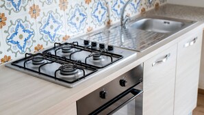 A kitchen with a gas stove, a sink, and a dishwasher.