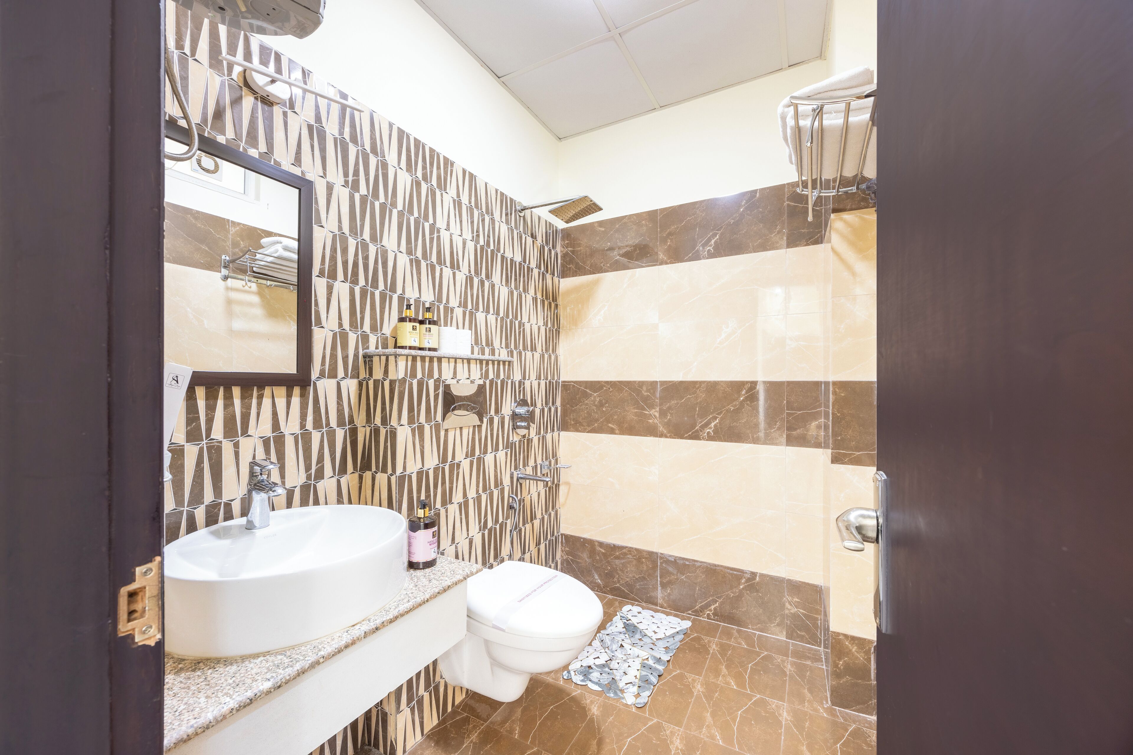 A bathroom with a sink, toilet, and shower.