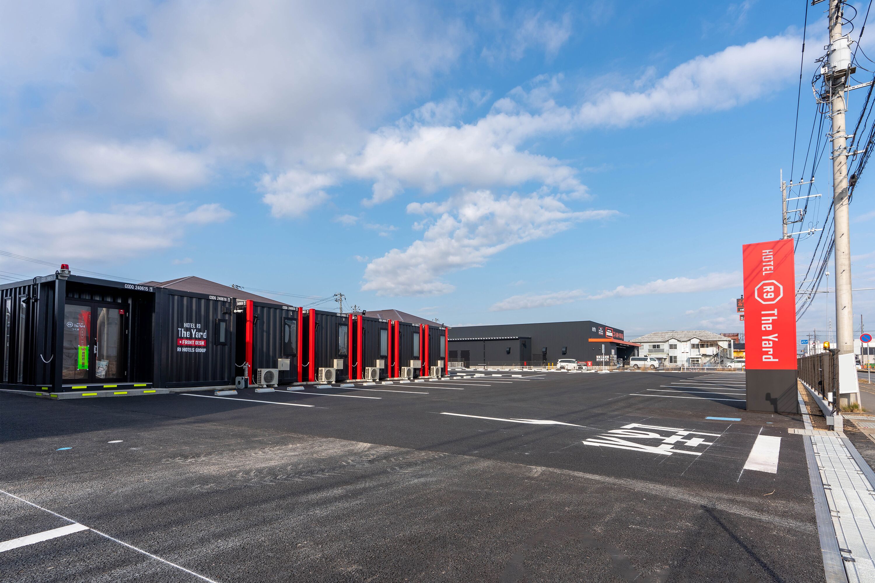 A hotel with a modern design, featuring a prominent red and black color scheme.