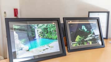 Two framed photographs on a wooden surface.