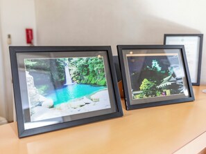 Two framed photographs on a wooden surface. - Kochi Terminal Hotel (Kochi)