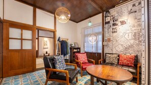 A traditional Japanese room with tatami flooring, a wooden ceiling, and a map on the wall. - victory guesthouse (Pingtung)