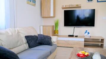 House (Four Bedroom Holiday Home with Pool) | Living room | 32-inch flat-screen TV with cable channels