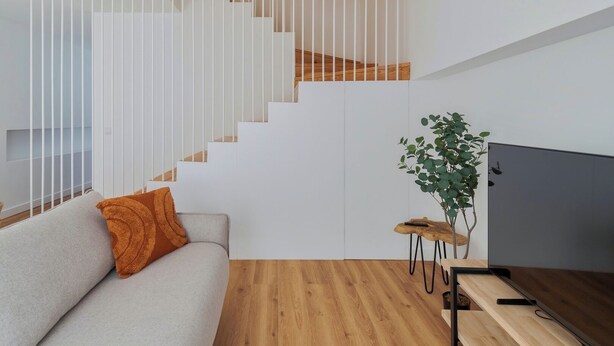 A modern living room with a staircase, a sofa, a coffee table, and a television. - Simple Life II, Setúbal (Setúbal)
