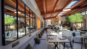 A restaurant with a long counter, seating area, and a bar. - Pax Manor Muthaiga (Nairobi)