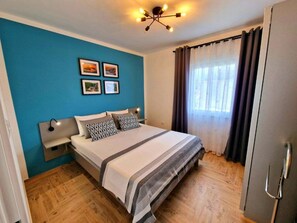 Relax in this inviting space with a large bed, wall-mounted light, and framed artwork.