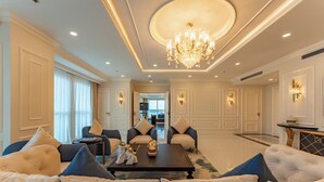 A spacious living room with a chandelier, plush sofas, and a coffee table. - Cosmo Stars Hotel Bac Lieu (Bac Lieu)