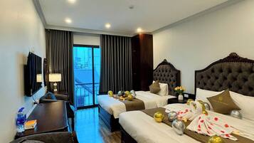 A hotel room with two beds, a desk, a chair, and a large window.
