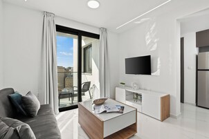 Standard Apartment, City View | Living area | 40-inch flat-screen TV with satellite channels