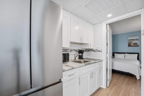Fridge, microwave, coffee/tea maker, cookware/dishes/utensils