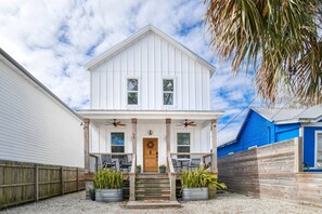 A two-story house with a porch, a wooden door, and two windows. - 70 Oneida Street (St. Augustine)