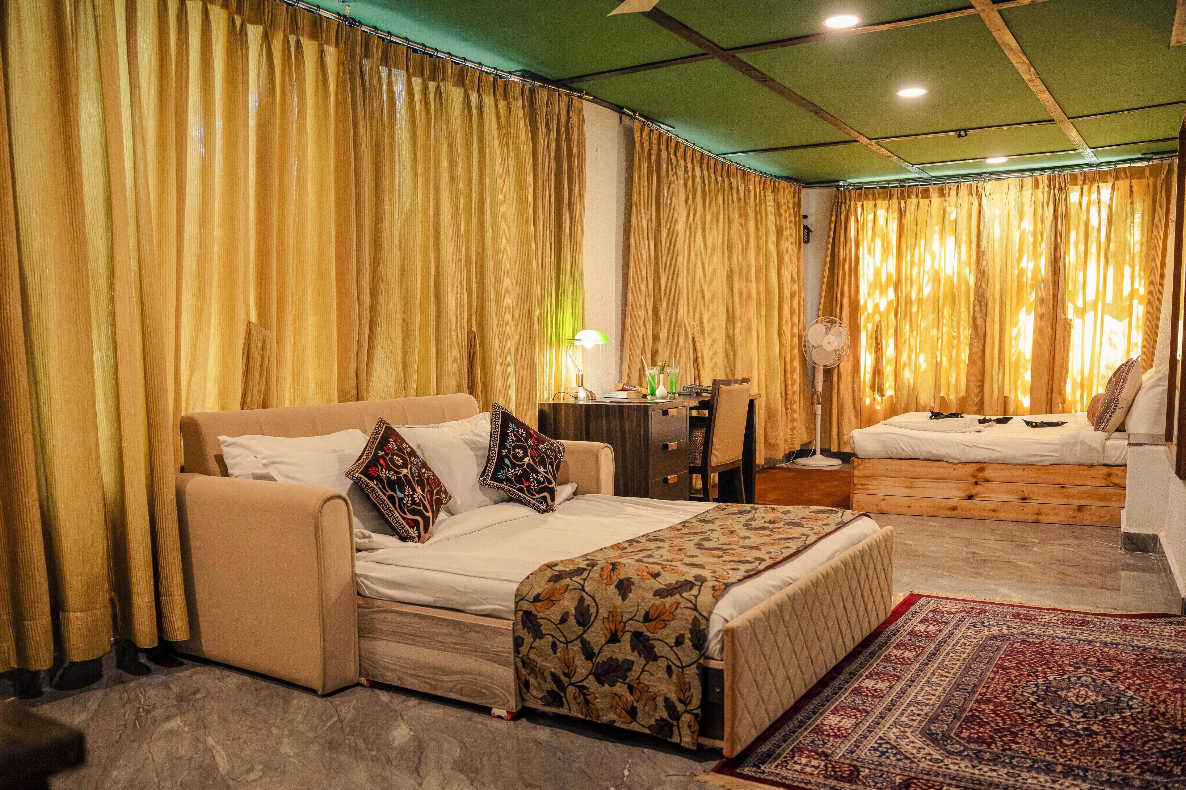 A bedroom with a bed, a desk, and a chair.