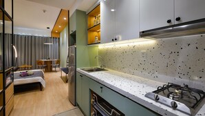 Una cocina moderna con estufa a gas, un lavamanos y un comedor con mesa y sillas.