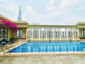 A swimming pool with a clear view of tall buildings in the background. - 2Q Apartment  (Ho Chi Minh City)
