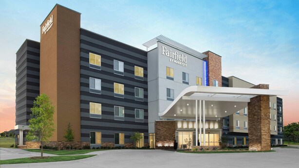 A Fairfield by Marriott hotel with a modern design, featuring a prominent entrance and multiple floors.