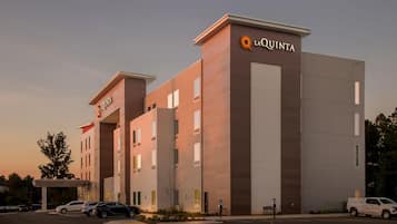 A hotel with a modern design, featuring a prominent 'La Quinta' sign on the facade.