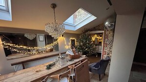 A cozy kitchen with a wooden bar, a Christmas tree, and a skylight. - Stone Cottage Norfolk , Lovely Family Cottage (Norwich)