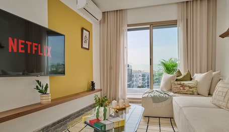 Deluxe Apartment | Living area | 60-inch Smart TV with digital channels, Netflix, streaming services