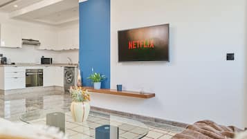 Comfort Apartment | Living area | 60-inch Smart TV with digital channels, Netflix, streaming services