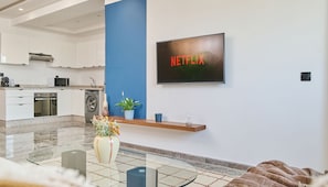 Comfort Apartment | Living area | 60-inch Smart TV with digital channels, Netflix, streaming services - StayHere Casablanca - Oasis - Premium Residence (Casablanca)