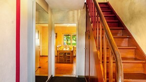 A staircase leading to a dining area with a wooden interior and a view of the outdoors. - Holiday Home 'Ferienhaus Lüttje Dörp' with Private Terrace, Private Garden and Wi-Fi (Blomberg)