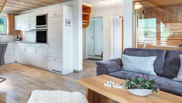 A modern interior with a kitchen, living area, and a wooden ceiling. - Holiday Apartment 'Type B1, 50sqm' with Mountain View, Shared Terrace and Wi-Fi (Feldberg (Schwarzwald))