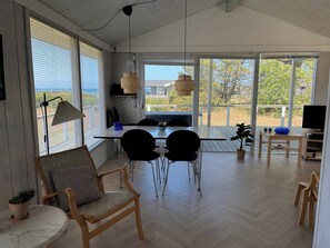 Ein moderner Essbereich mit Tisch, Stühlen und Blick ins Freie.