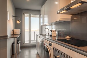 Apartment | Private kitchen | Microwave, coffee/tea maker, highchair, dining tables