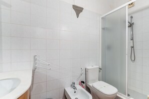 Een douche, een haardroger, een bidet, handdoeken
