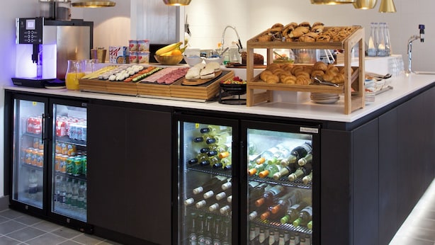A buffet area with a variety of food items, a coffee machine, and beverage dispensers. - The Z Hotel Tottenham Court Road (London)