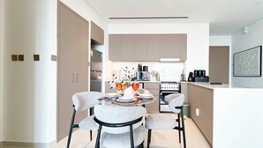 A modern kitchen with a dining area. - Luxurious 1BR at Grande Downtown With Iconic Views (Dubai)