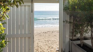 A beach view through an open door, sandy beach, and ocean waves. - New Bussola (Quartu Sant'Elena)