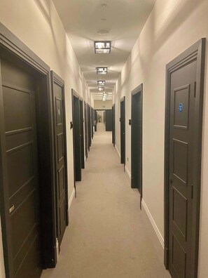 Guest rooms lead from this well-lit corridor.