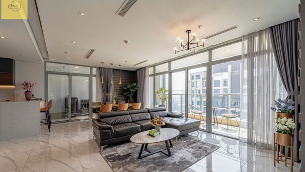 A modern living room with a sofa, coffee table, and large windows offering a city view. - Landmark 81 Magical Tower Apartment (Ho Chi Minh City)