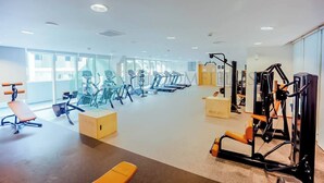 A spacious gym with treadmills, stationary bikes, and weight machines. - Bloomfields Adorable 1BR in Raha Beach Access (Abu Dabi)