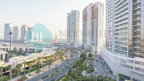 A modern urban area with high-rise buildings, roads, and palm trees. - Bloomfields STU In Carson (Dubai)