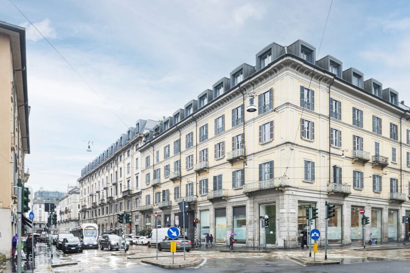 A multi-story building with a classic architectural style, featuring a central courtyard and a series of balconies.