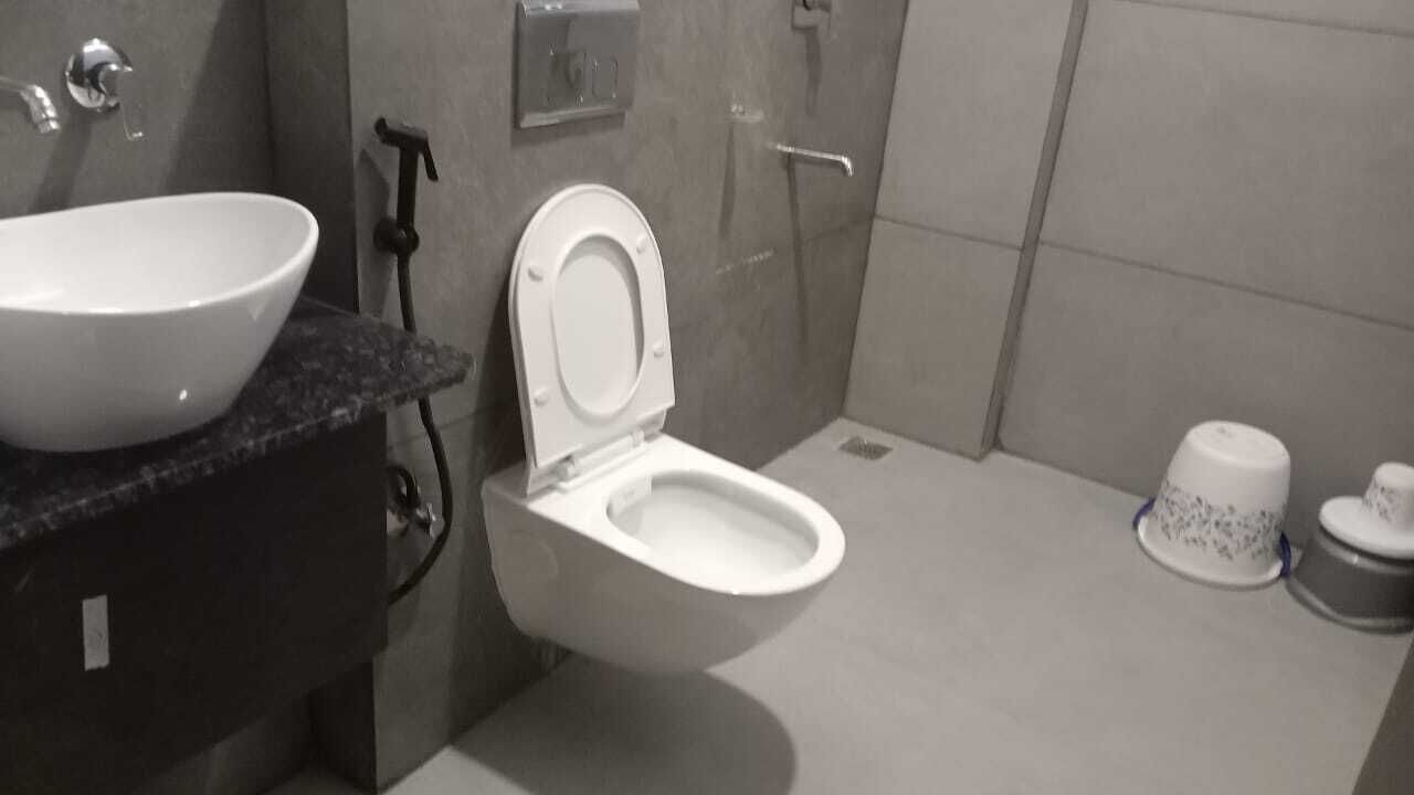A bathroom with a white sink, toilet, and bidet.