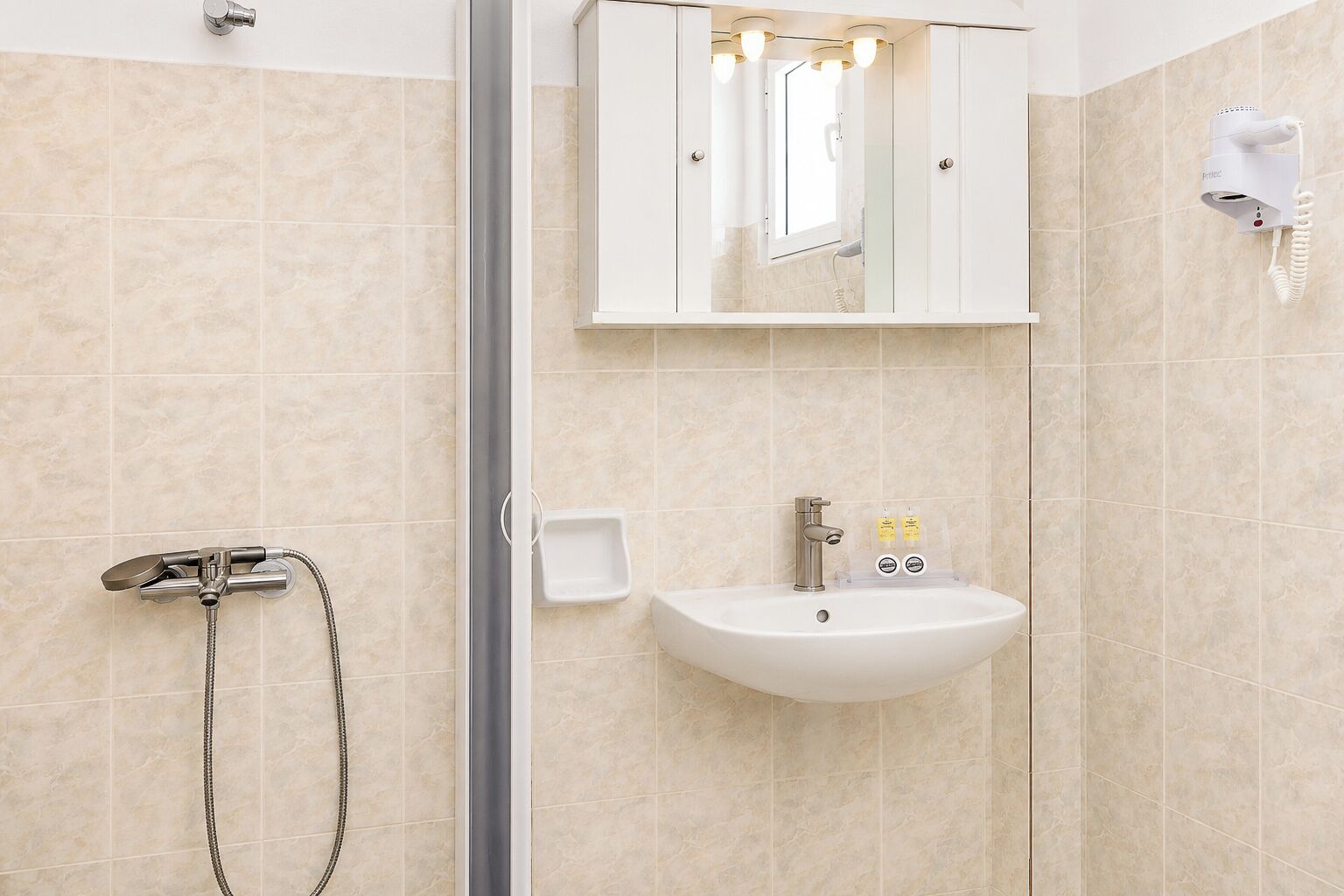 Shower, hair dryer, towels, soap