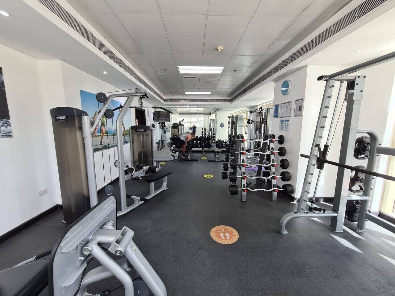A gym with various exercise equipment, including weight machines and free weights.