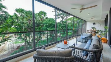 Deluxe Apartment, 3 Bedrooms | Living area | 65-inch Smart TV with digital channels