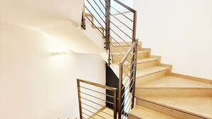 A staircase with a metal railing and beige steps. - Apartment in the center of Levico with 3 bedrooms, 2 bathrooms, terrace,garage and elevator (Levico Terme)