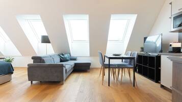 Royal Quadruple Room, Balcony | Living area | 60-cm Smart TV with cable channels, heated floors, printers