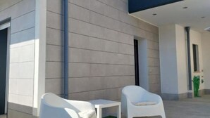 A modern building exterior with a clean, minimalist design, featuring a flat roof and large windows. - Sirene452 - where to combine the relaxation of the sea and the proximity to the eternal city (Torvaianica)