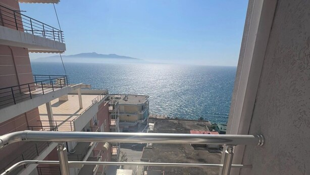 A balcony with a metal railing overlooking a coastal view. - Albania Dream Holidays Apartment (Sarandë)