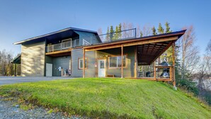 A two-story house with a covered porch, a garage, and a small deck. - Kenai River Views & Access: Soldotna Apartment! (Soldotna)