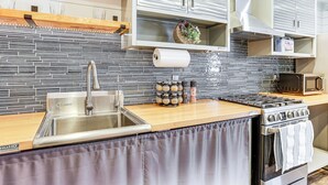 A modern kitchen with a stainless steel sink, wooden countertop, and a built-in oven. - 1 Mi to Chickamauga Lake: Apartment in Soddy-daisy (Soddy-Daisy)