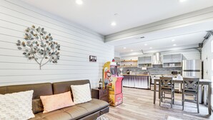 A modern living room with a brown leather sofa, a coffee table, and a kitchen area with stainless steel appliances and wooden cabinets. - 1 Mi to Chickamauga Lake: Apartment in Soddy-daisy (Soddy-Daisy)
