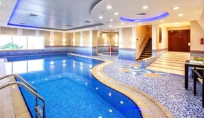 A swimming pool with a tiled deck, a staircase, and a door in the background. - Renovated Unit w/ Skyscraper Views Close to Beach, Elite Residence,Dubai Marina (Dubai)