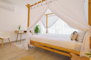 A room with a bed, a desk, and a chair.
